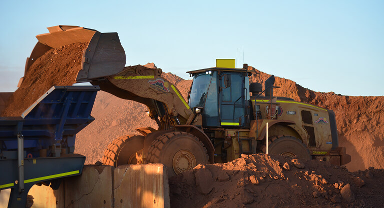 Heavy machinery performing mining services and earthworks